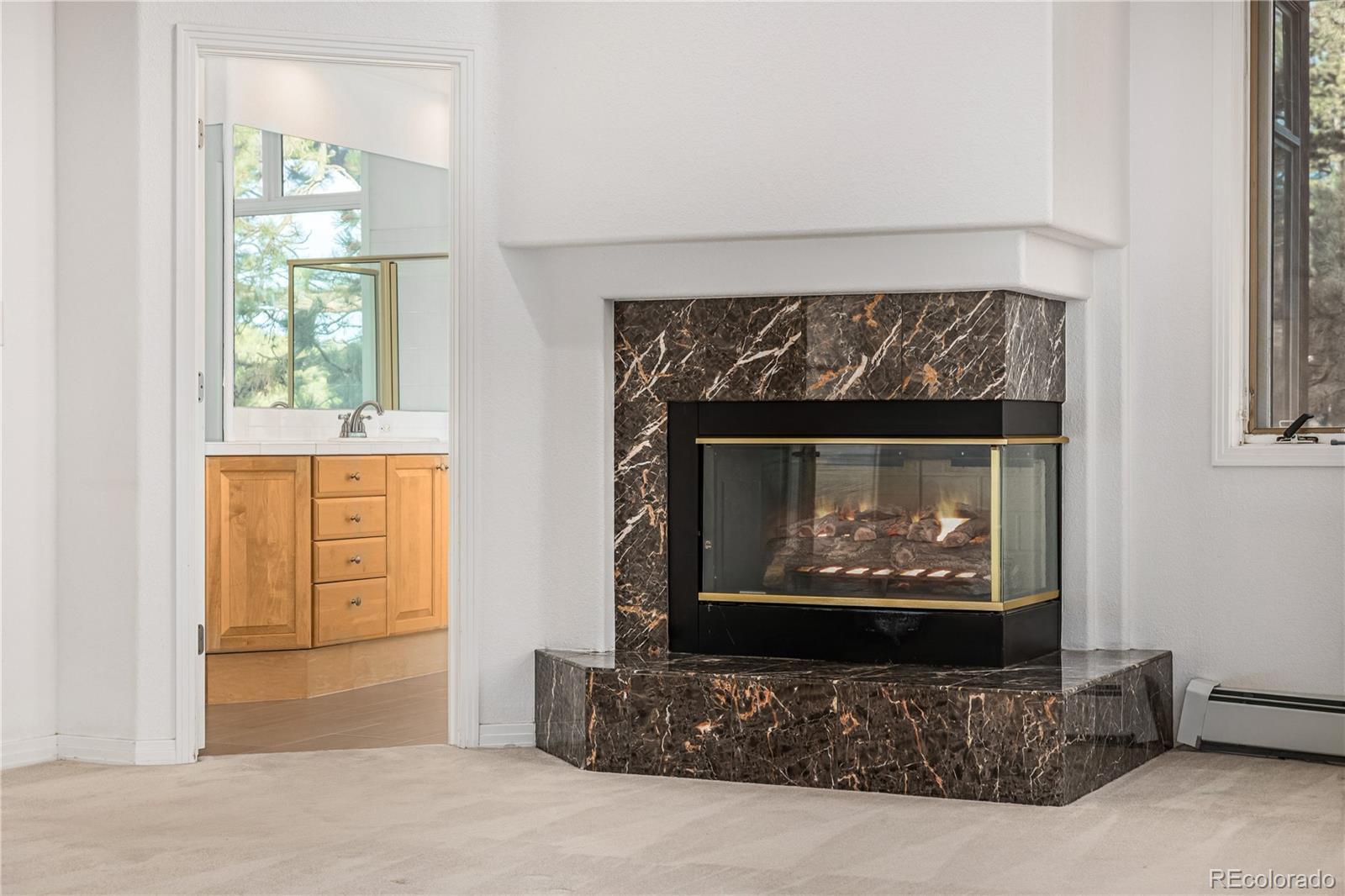 941 Sleepy Hollow Road Golden, CO 80401 - Photo 21 of 50 a living room with furniture a fireplace and a window