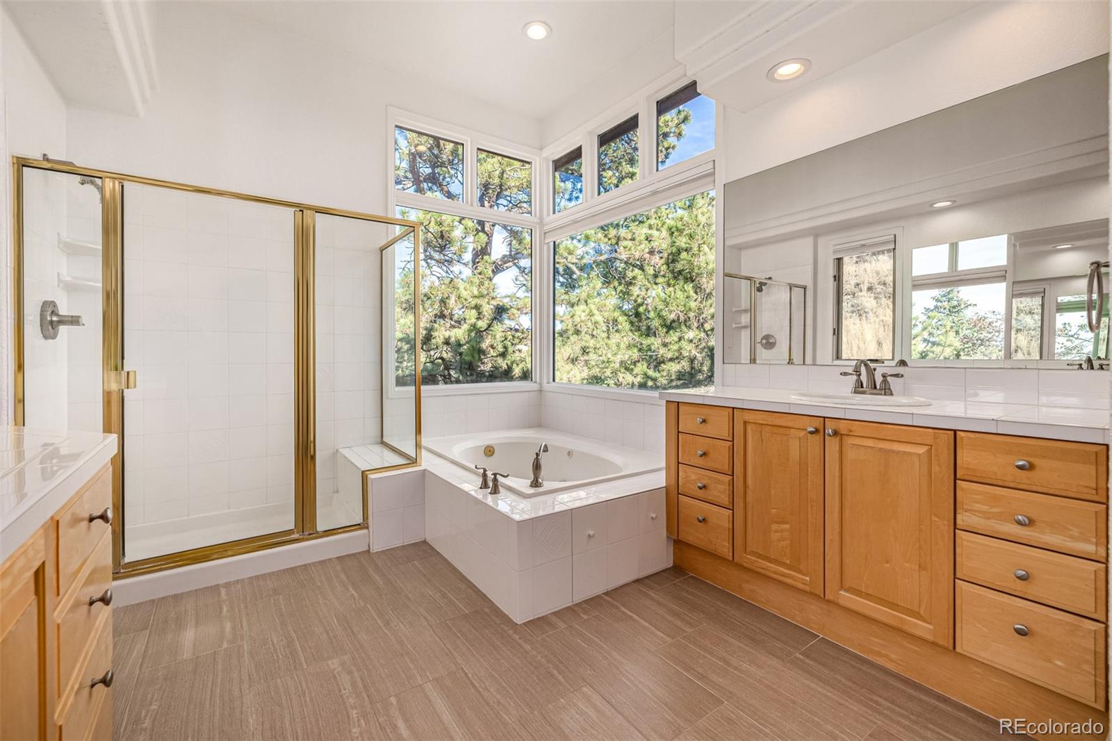 941 Sleepy Hollow Road Golden, CO 80401 - Photo 22 of 50 a spacious bathroom with a tub a sink and mirror
