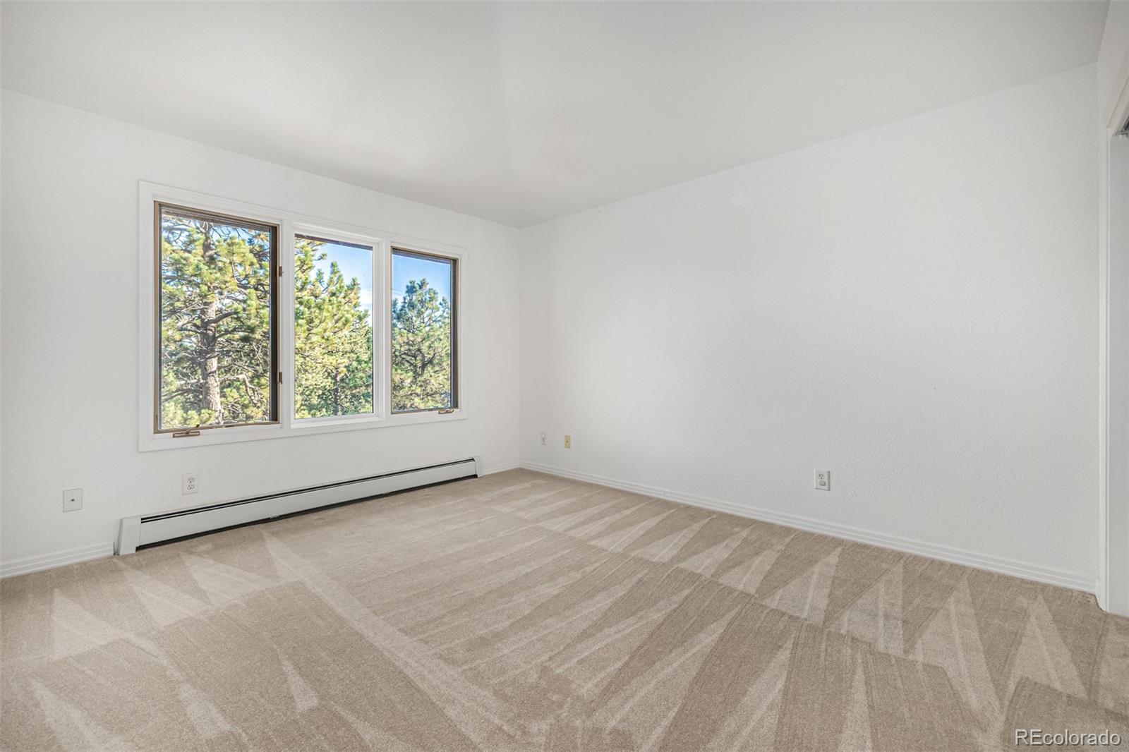 941 Sleepy Hollow Road Golden, CO 80401 - Photo 25 of 50 an empty room with a window