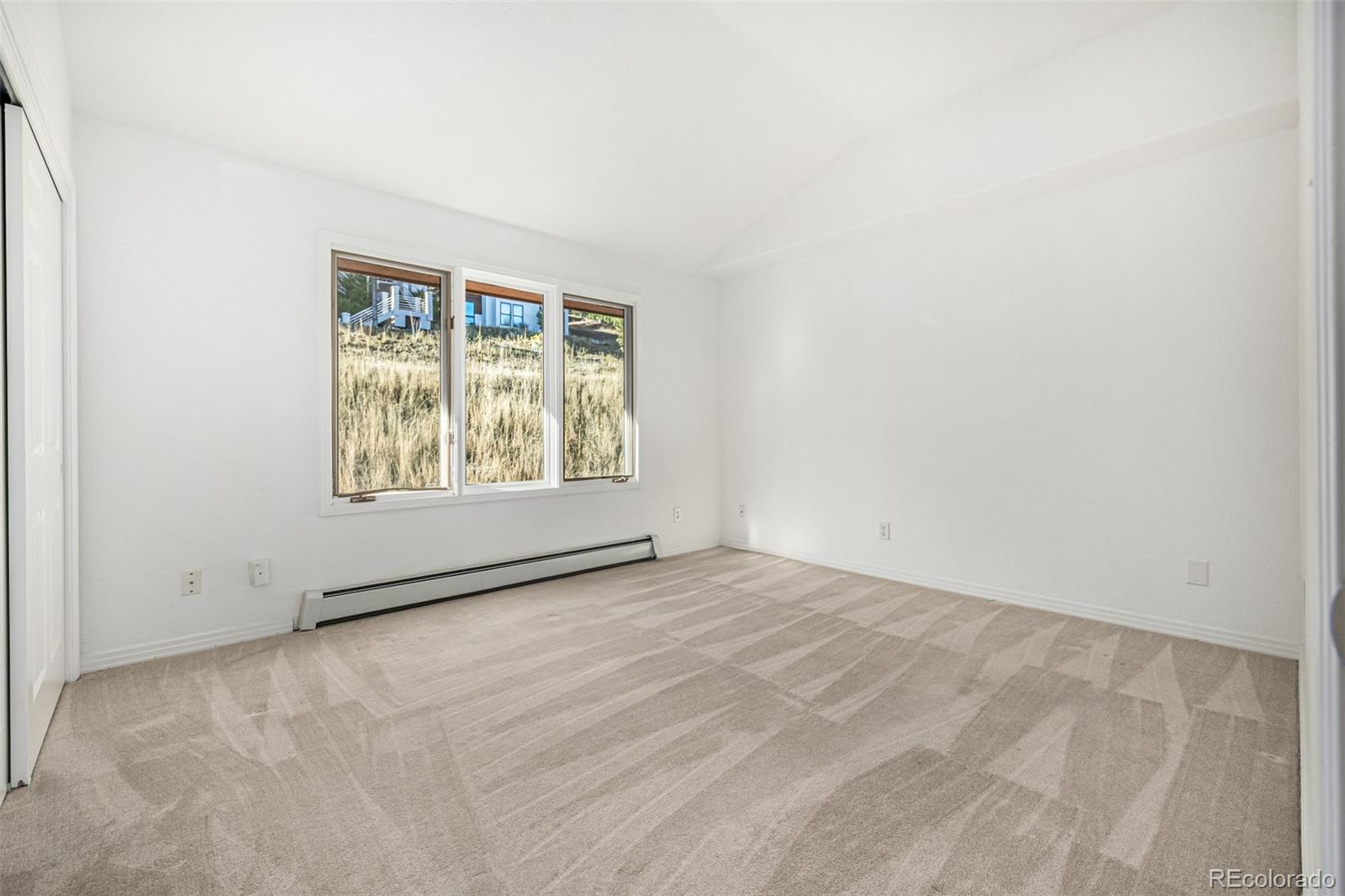 941 Sleepy Hollow Road Golden, CO 80401 - Photo 27 of 50 an empty room with windows