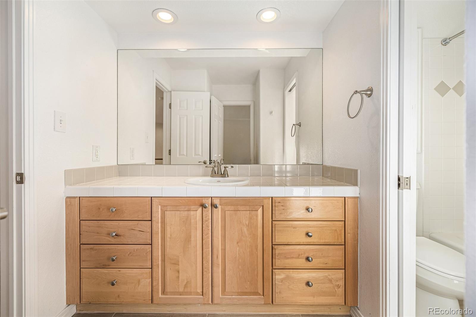 941 Sleepy Hollow Road Golden, CO 80401 - Photo 28 of 50 a bathroom with a granite countertop sink a mirror and a vanity