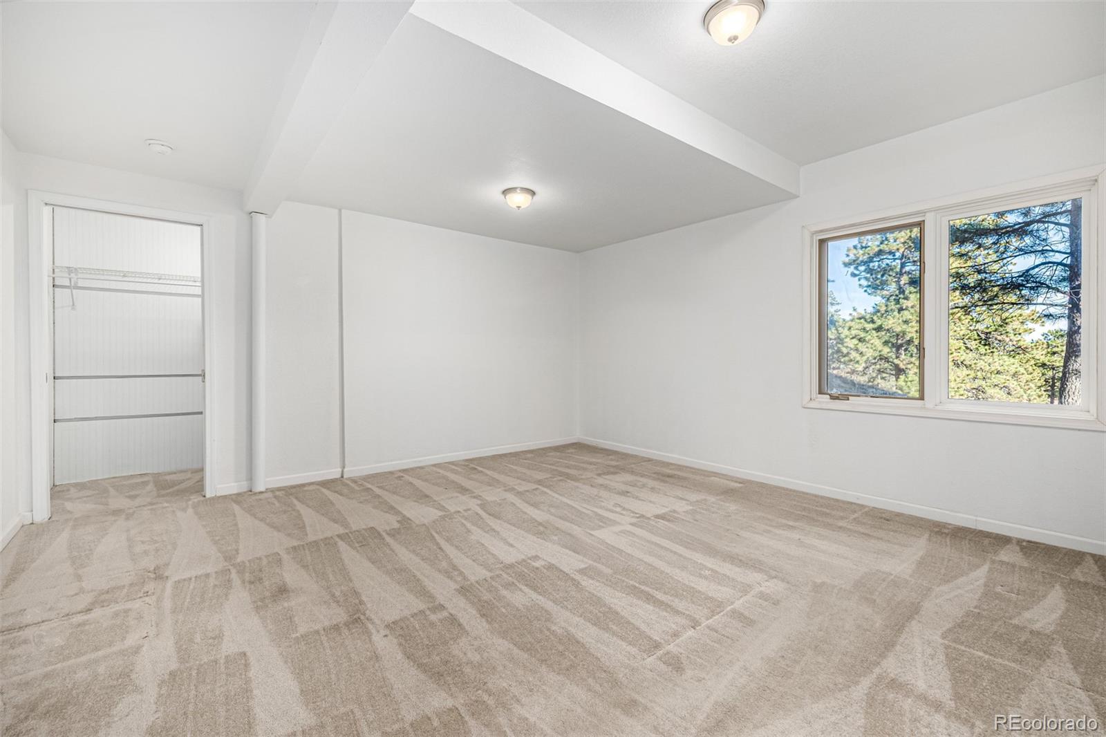 941 Sleepy Hollow Road Golden, CO 80401 - Photo 35 of 50 a view of empty room with window and ceiling fan
