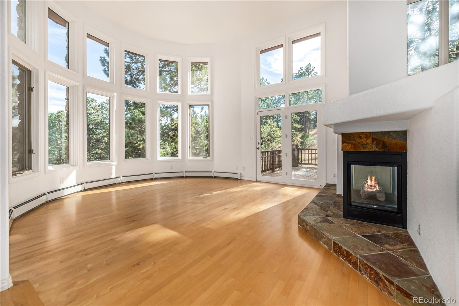 941 Sleepy Hollow Road Golden, CO 80401 - Photo 4 of 50 a view of an empty room with a fireplace and a window
