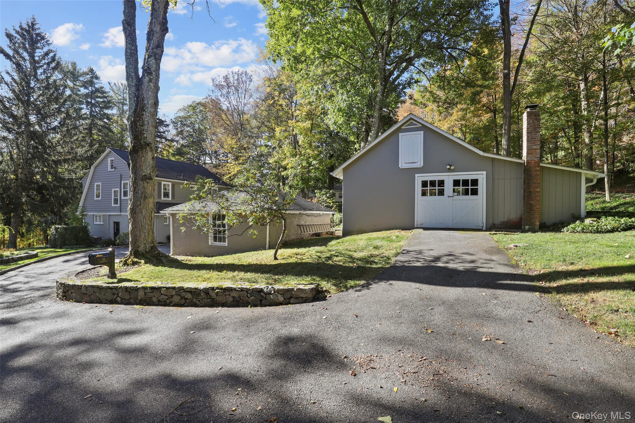35 Hamilton Road Chappaqua, NY 10514 - Photo 20 of 29 a front view of a house with a yard and garage