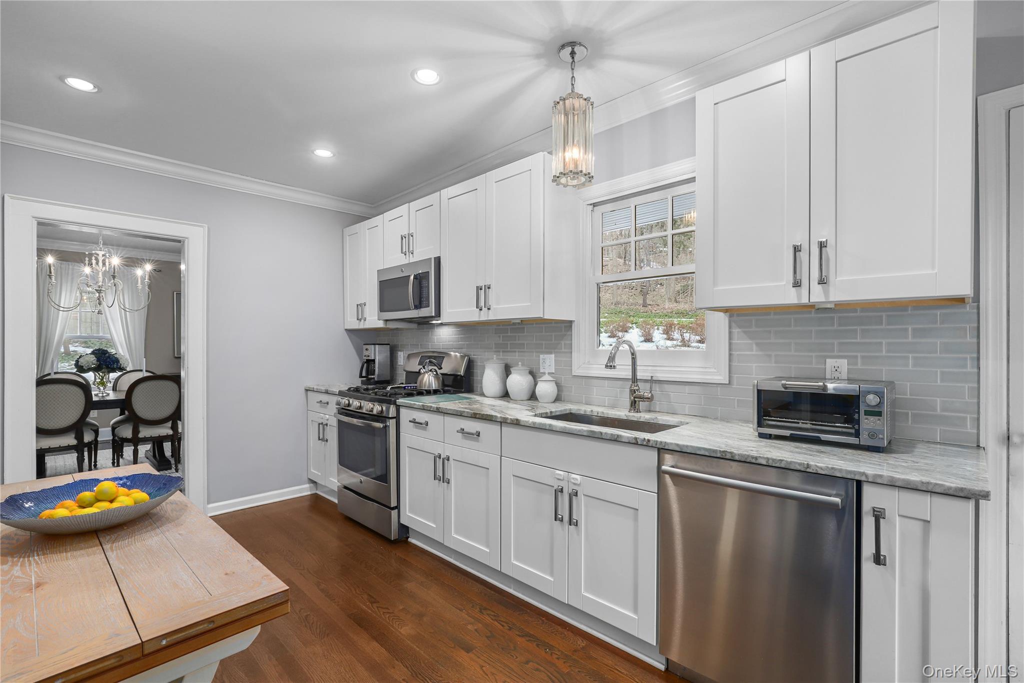 35 Hamilton Road Chappaqua, NY 10514 - Photo 6 of 29 a kitchen with stainless steel appliances granite countertop a sink a stove and a refrigerator