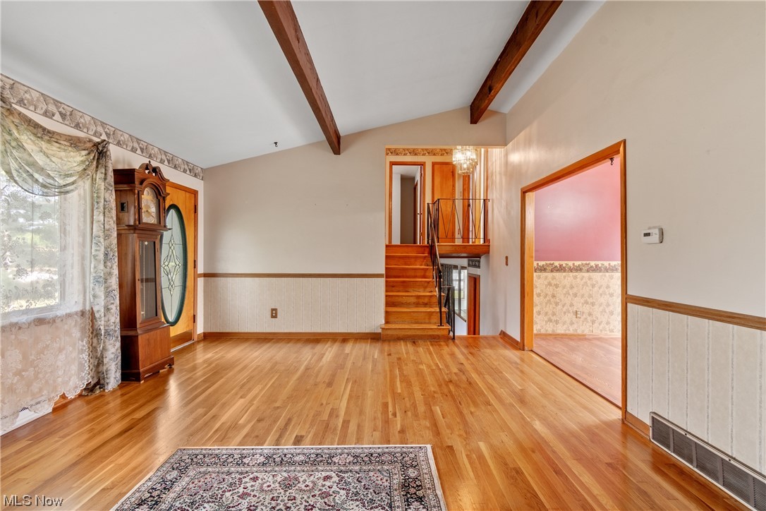 120 Lester Road New Franklin, OH 44319 - Photo 4 of 24 Spare room featuring light hardwood flooring and lofted ceiling with beams