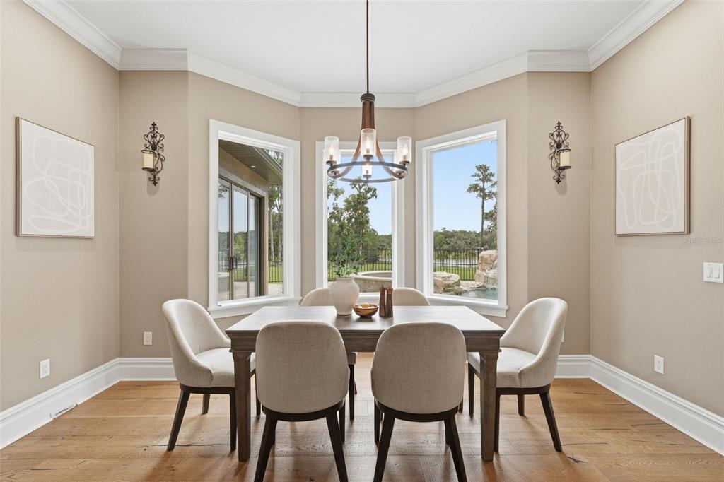 855 Southeast 87th Street Ocala, FL 34480 - Photo 18 of 79 a dining room with furniture a chandelier and wooden floor
