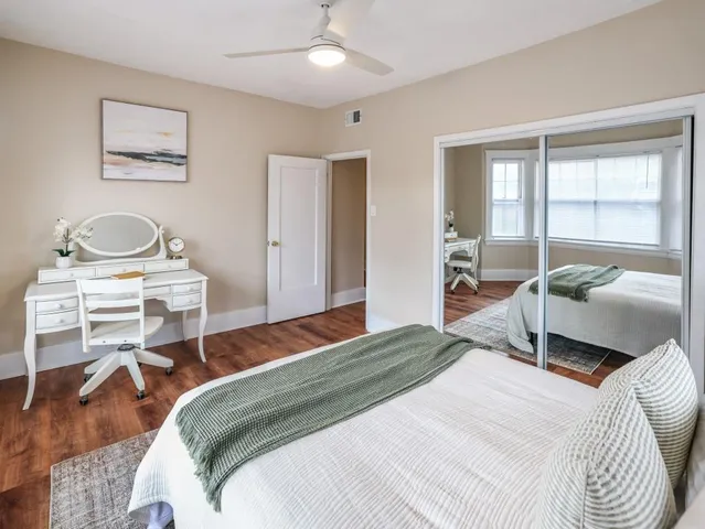 a bedroom with a bed and a chair