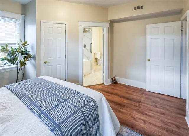 a bedroom with a bed and a potted plant