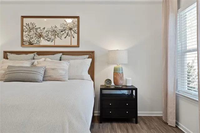 a view of a dining room and livingroom with furniture wooden floor a chandelier