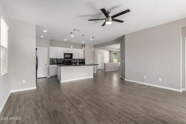 a view of a kitchen with a sink and wooden floor
