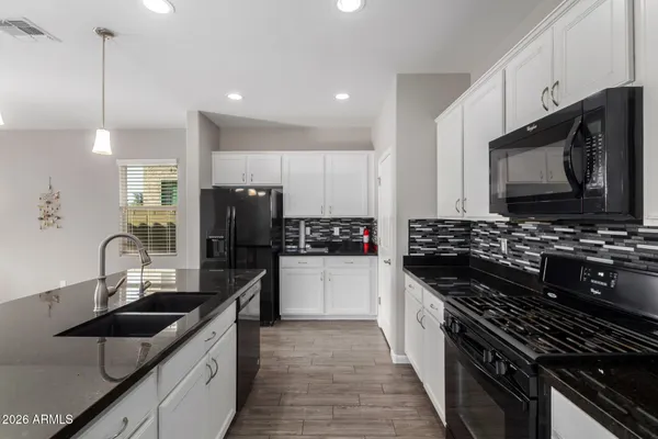 a kitchen with stainless steel appliances a sink stove and refrigerator
