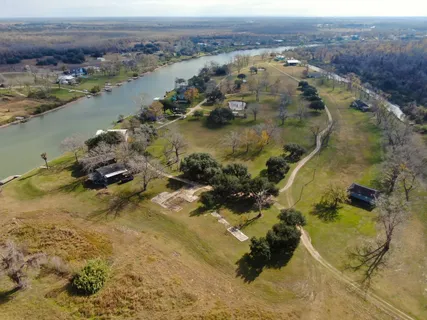 an aerial view of lake residential house and ocean view