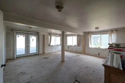 a view of empty room with window and fireplace