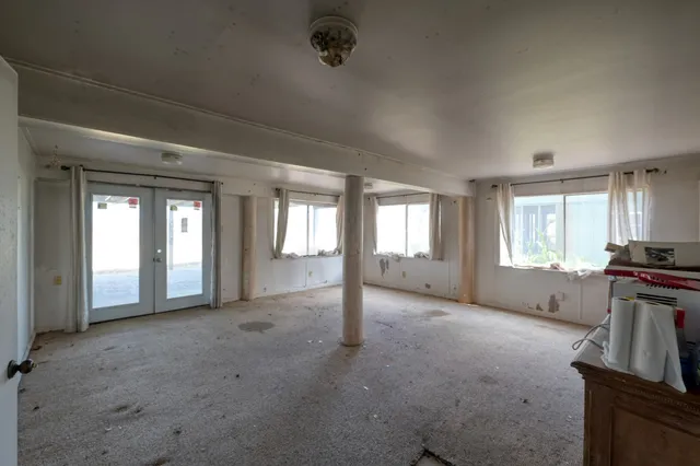 a view of empty room with window and fireplace