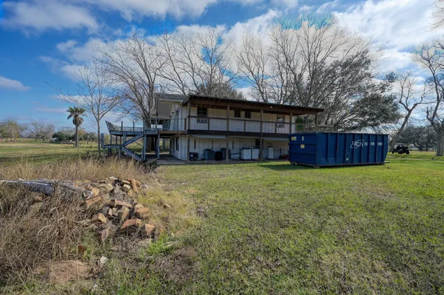 a view of a house with a yard and sitting area