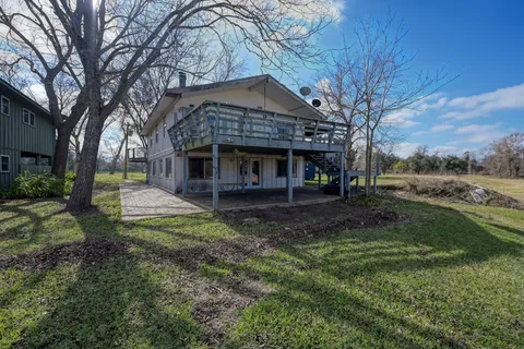 a view of a house with a yard and tree s