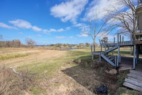 a view of a yard with a house and wooden fence