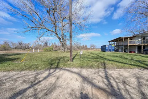 a view of a house with yard and green space