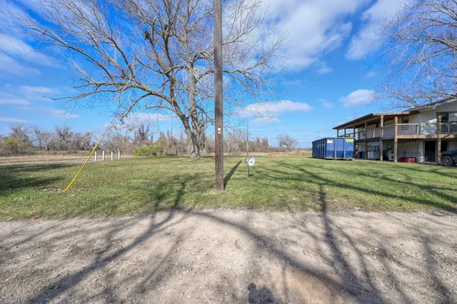 a view of a house with yard and green space