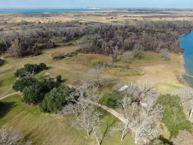 an aerial view of residential houses with outdoor space and river