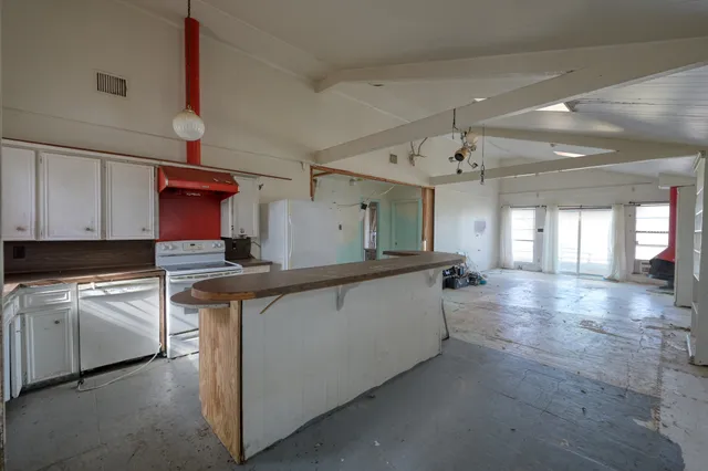 a kitchen with counter top space and cabinets