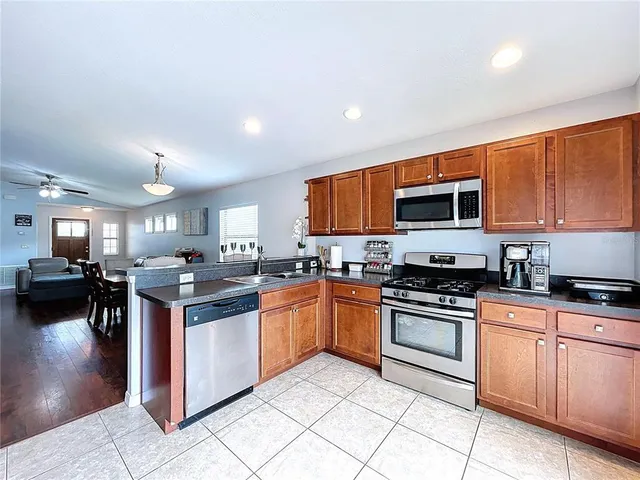a view of a sink a mirror and a lamp in a room