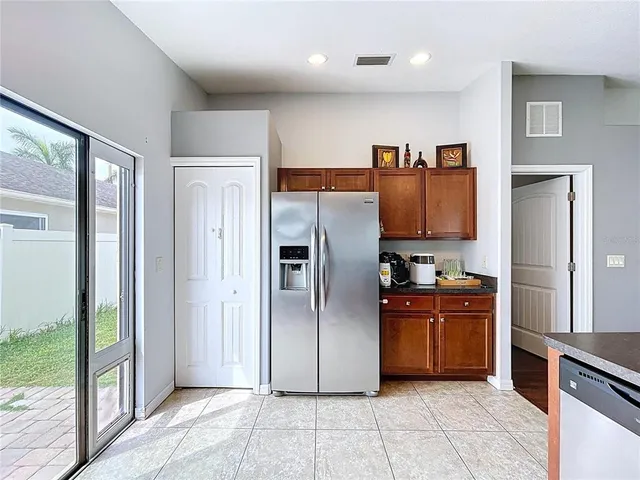 a en suite bathroom with a granite countertop sink and a mirror
