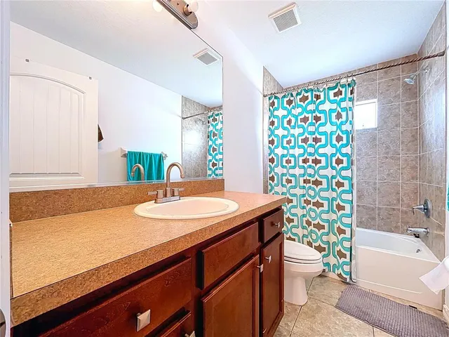 a view of a house with a small yard and a garage