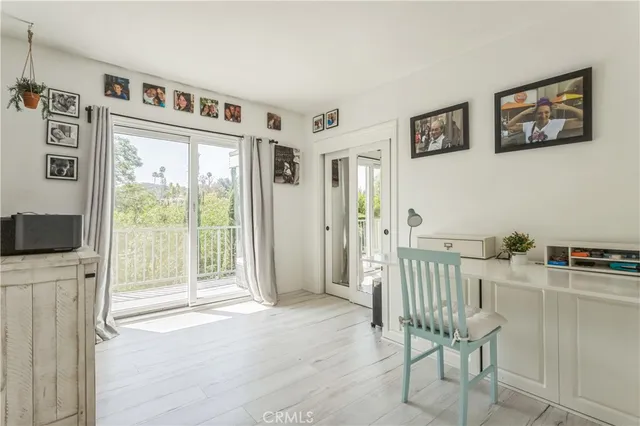 a view of a livingroom with workspace and a window