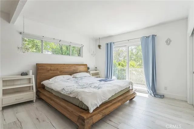 a bed sitting in a bedroom next to a window