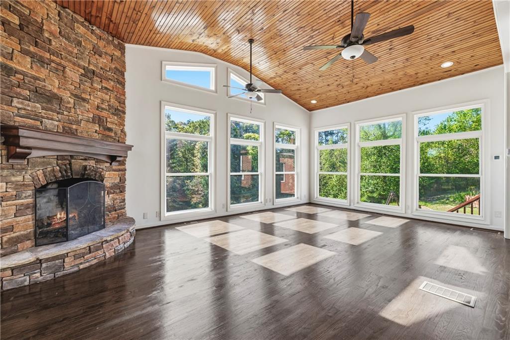 2240 Wilzman Trail Conyers, GA 30012 - Photo 20 of 72 a view of an empty room with wooden floor and a fireplace