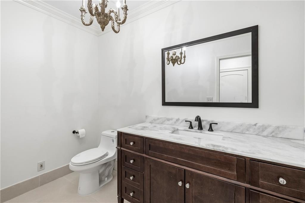 2240 Wilzman Trail Conyers, GA 30012 - Photo 33 of 72 a bathroom with a toilet a sink and mirror