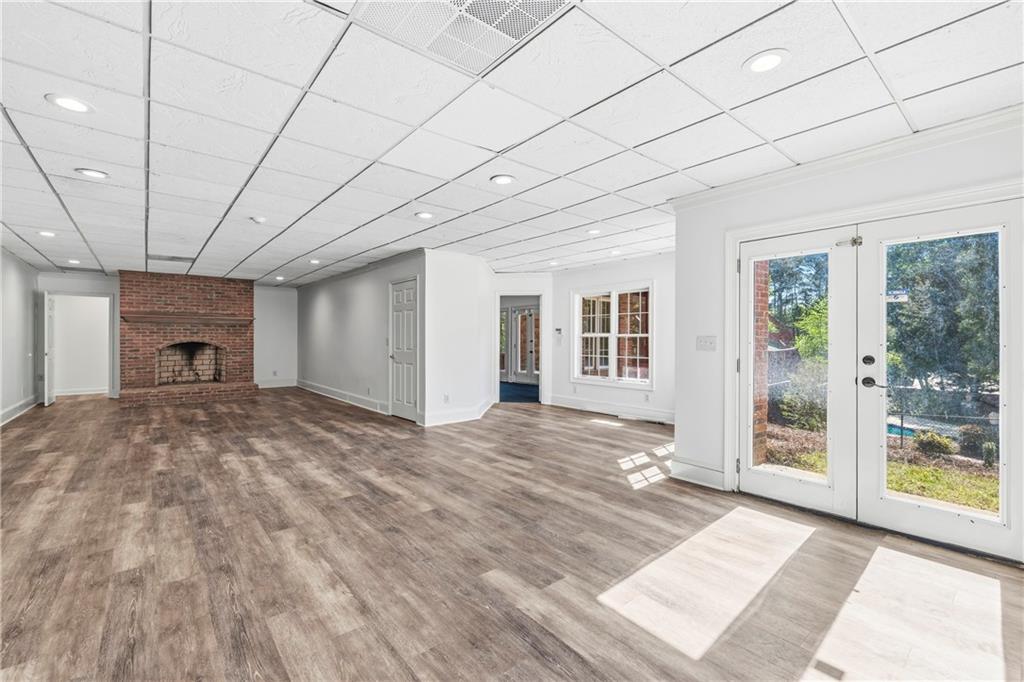 2240 Wilzman Trail Conyers, GA 30012 - Photo 37 of 72 a view of empty room with floor to ceiling window and fireplace