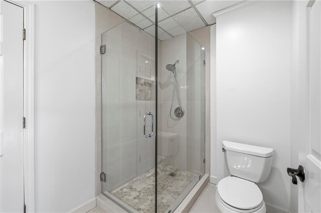 2240 Wilzman Trail Conyers, GA 30012 - Photo 47 of 72 a bathroom with a toilet and a shower
