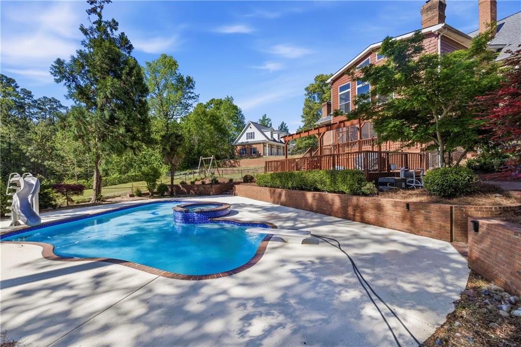 2240 Wilzman Trail Conyers, GA 30012 - Photo 53 of 72 a view of a swimming pool with a patio