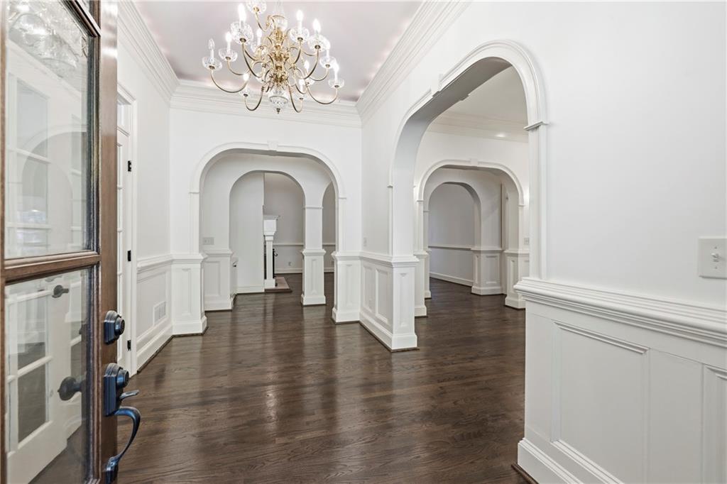 2240 Wilzman Trail Conyers, GA 30012 - Photo 6 of 72 a view of a hallway with entryway wooden floor and dining room view