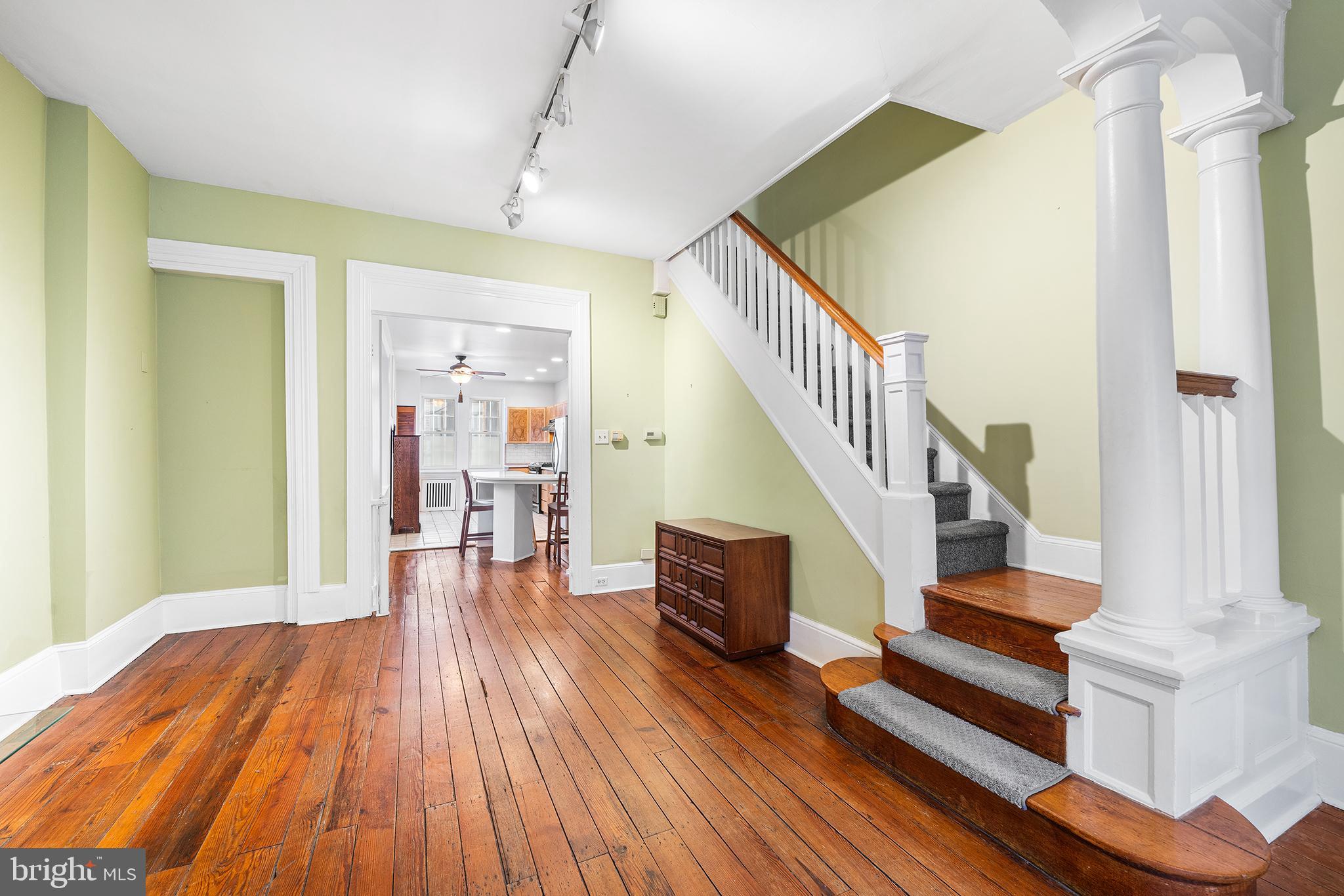 a view of entryway and hall with wooden floor
