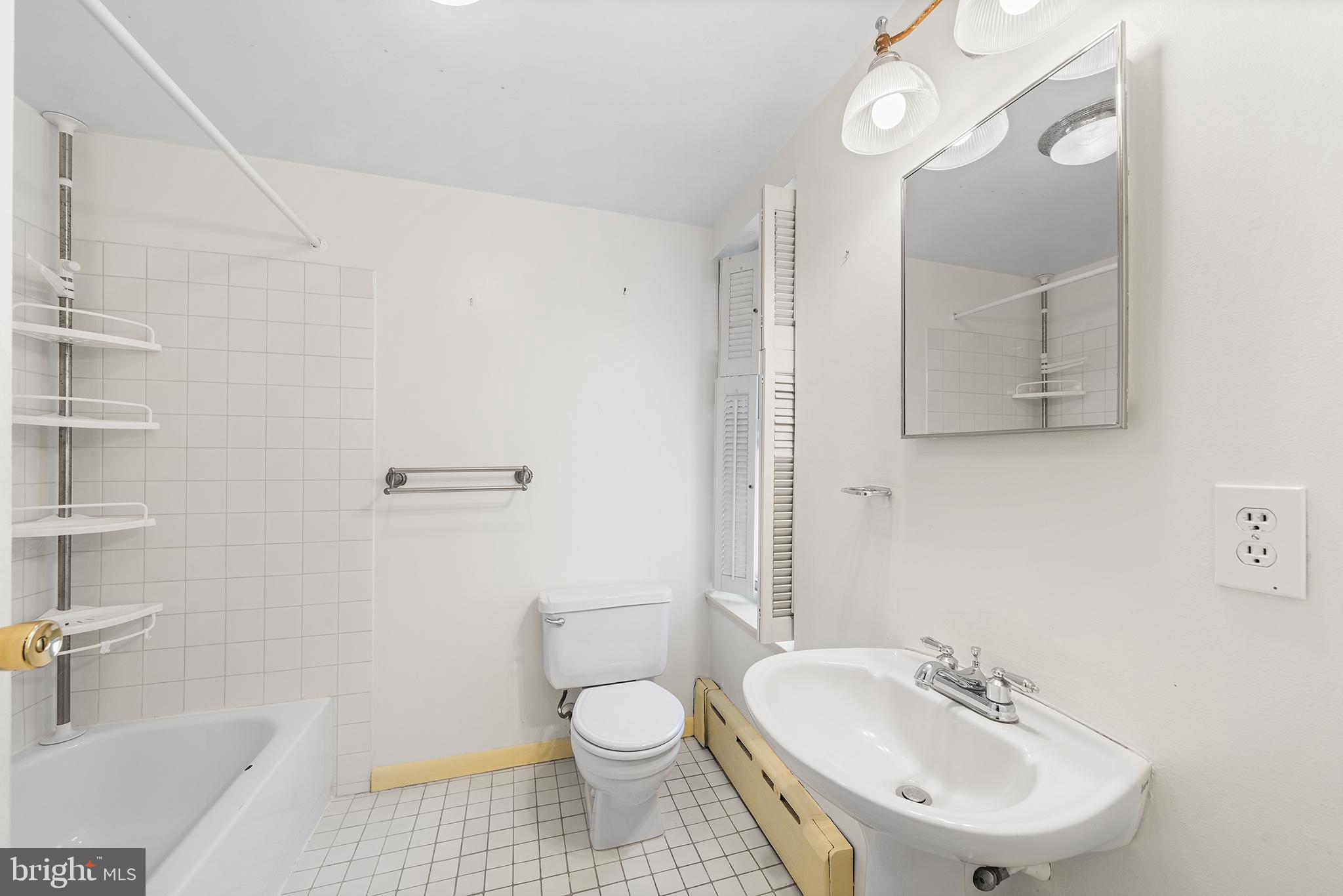 705 South Warnock Street Philadelphia, PA 19147 - Photo 27 of 28 a bathroom with a sink toilet a mirror and shower