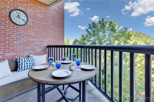 a view of a balcony with a table and chairs