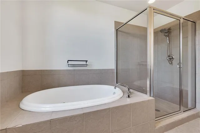 a bathroom with a bathtub and shower