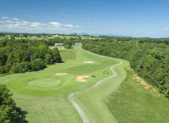 a view of a big yard with large trees