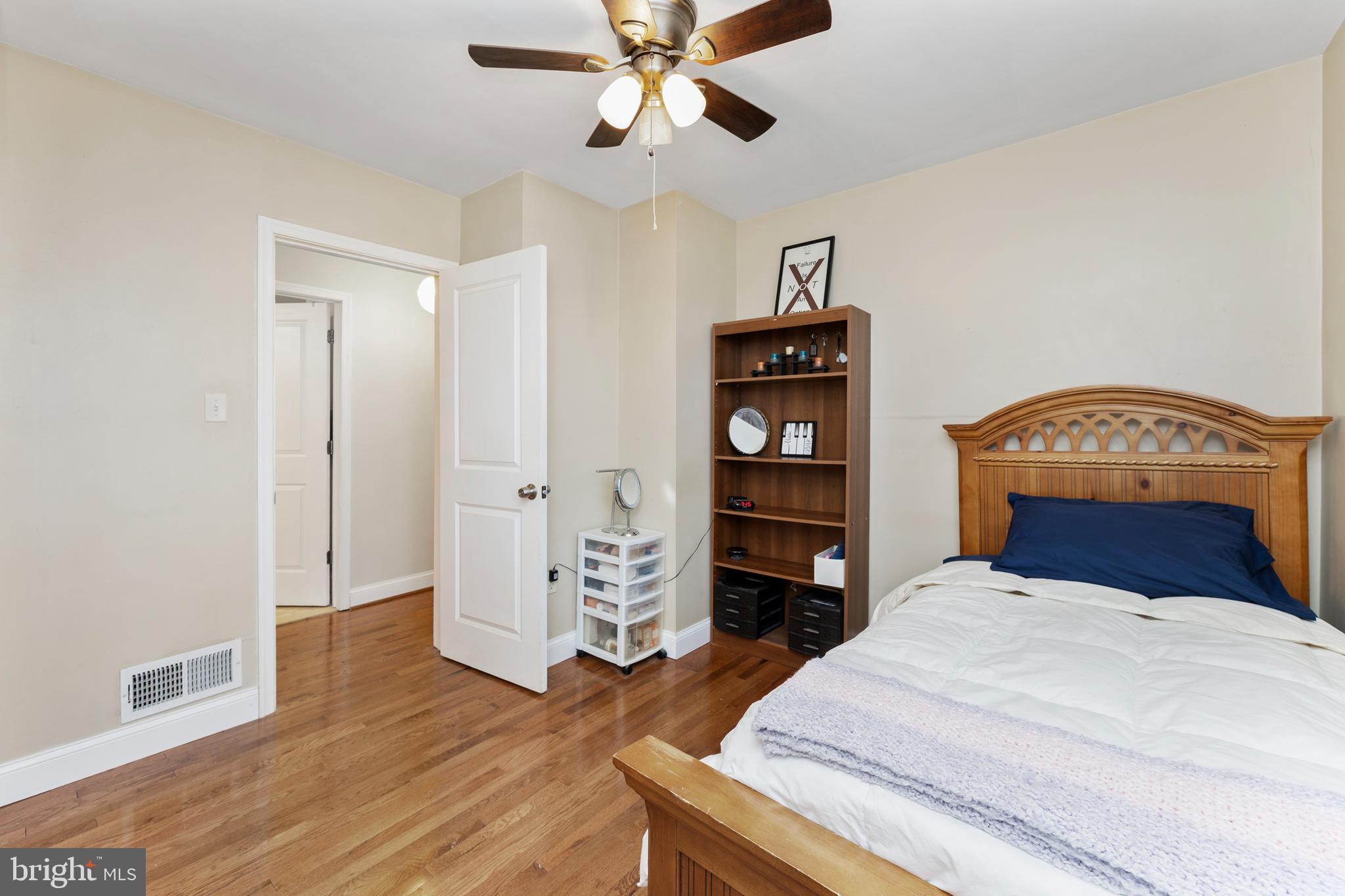 123 Walnut Street Northwest Washington, DC 20012 - Photo 17 of 59 a bedroom with a bed and wooden floor
