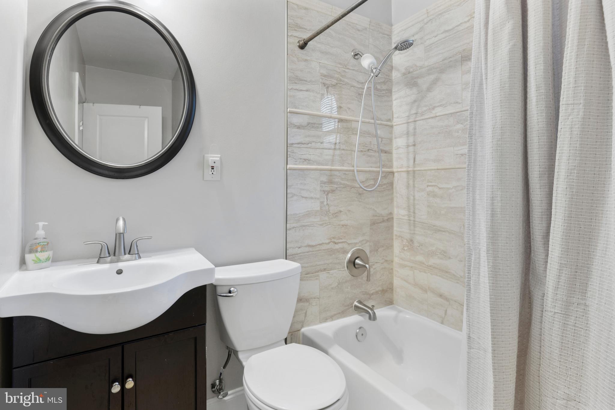 123 Walnut Street Northwest Washington, DC 20012 - Photo 19 of 59 a bathroom with a sink toilet and a mirror