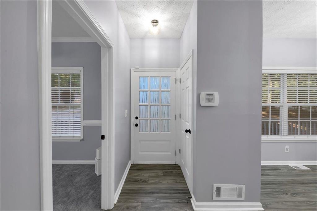 4735 Liberty Road Villa Rica, GA 30180 - Photo 1 of 1 a view of a hallway with wooden floor and a bathroom