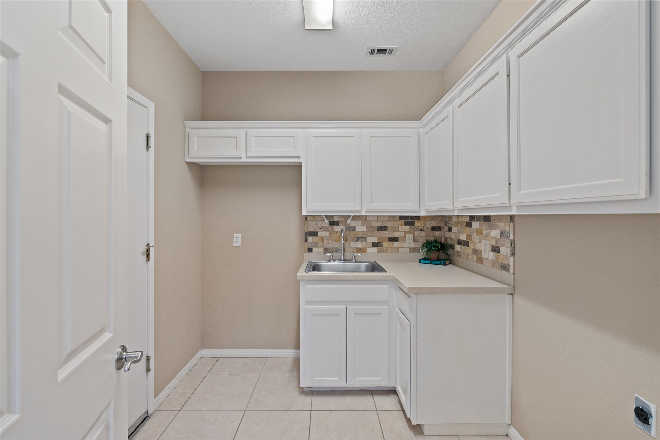 31000 Clearwater Court Georgetown, TX 78628 - Photo 19 of 39 a kitchen with a sink and cabinets