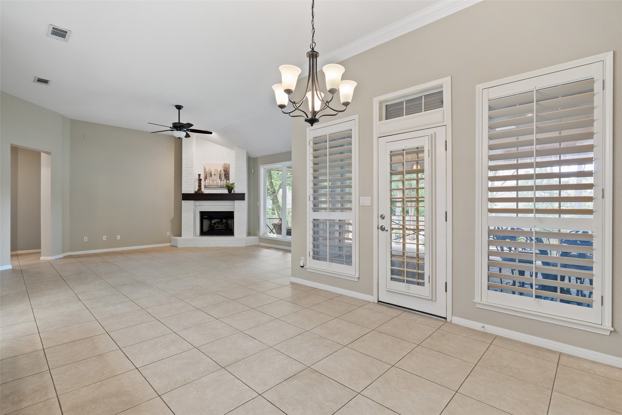 31000 Clearwater Court Georgetown, TX 78628 - Photo 22 of 39 a view of a livingroom with a chandelier fireplace and windows
