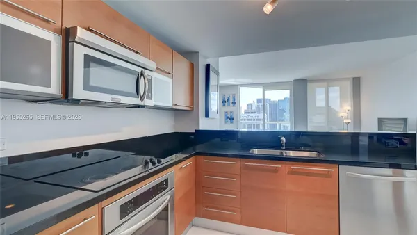 a kitchen with granite countertop cabinets and window