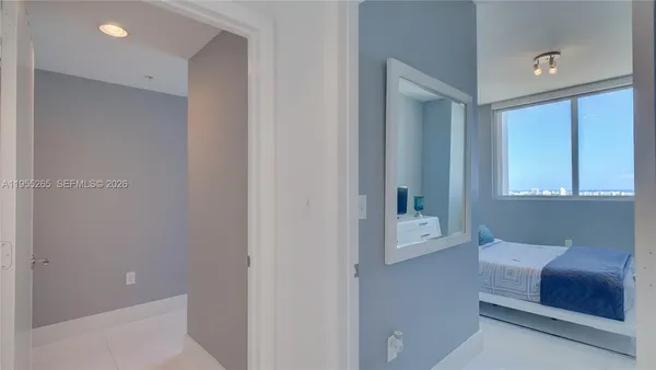a hallway with a couch and a window