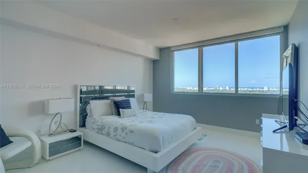 a bedroom with a bed and window